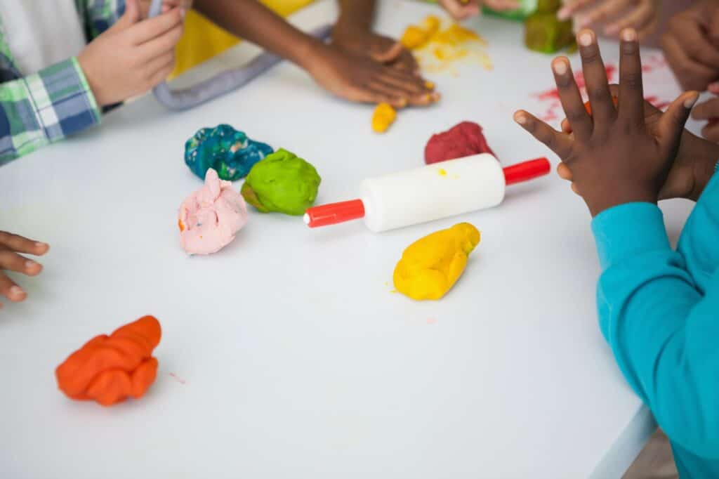 Cropped image of children's hands in an art class